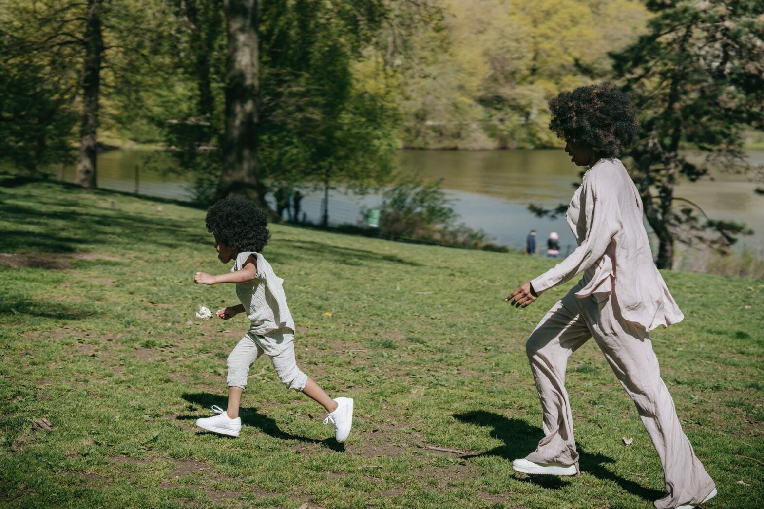 a woman chasing her child in a park