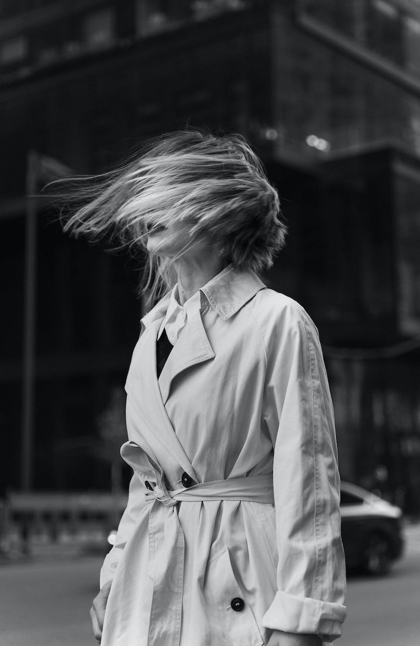 black and white shot of womans hair blowing in the wind